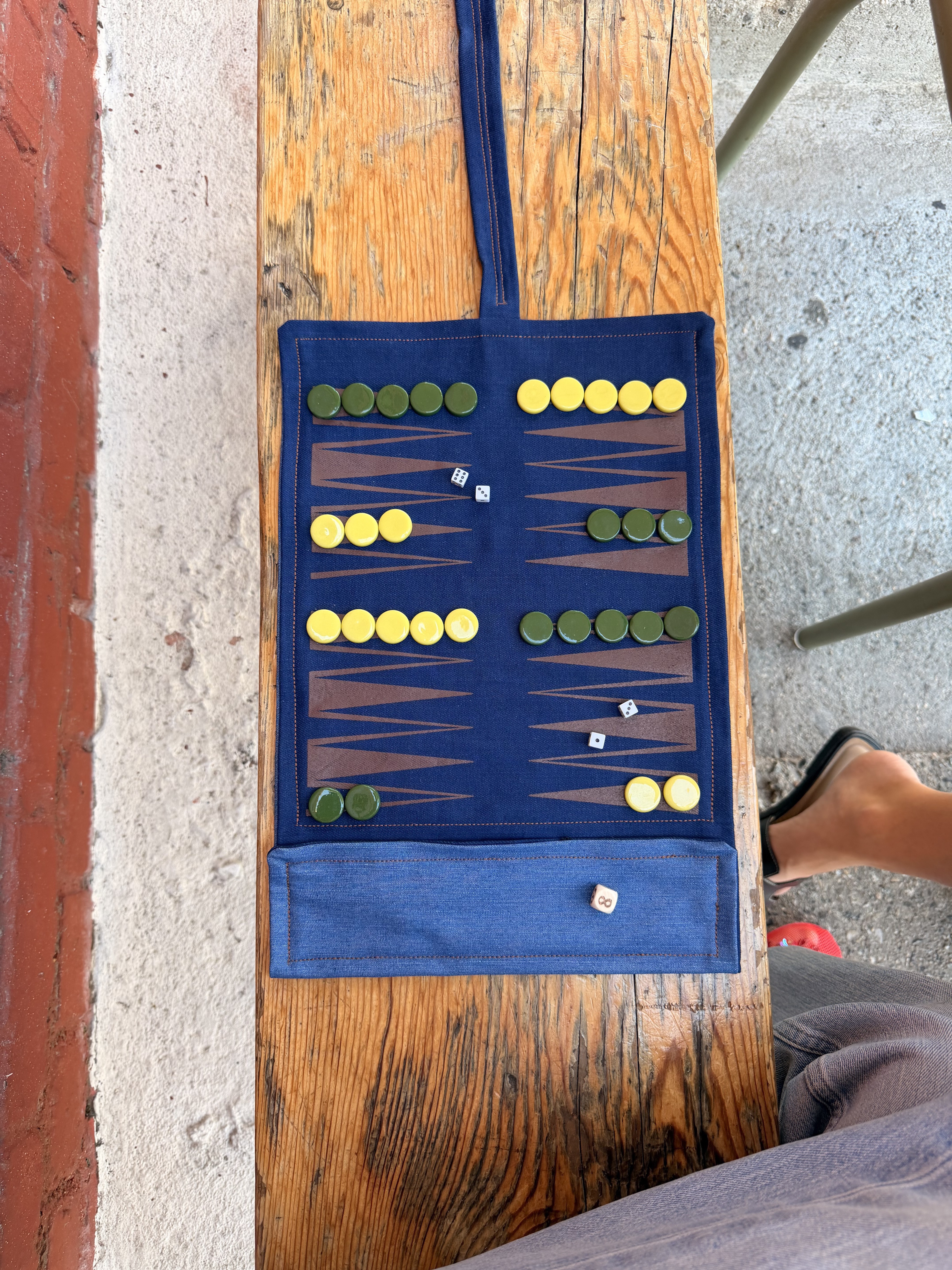 I'm Board backgammon board unrolled and being used at a café
